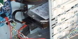 Installed 3.5-inch SATA hard disk drives showing the power and data cables attached to the drive and the data cable attached to the motherboard. 